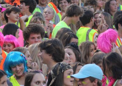 Groupd of students dressed in bright colors at a football game